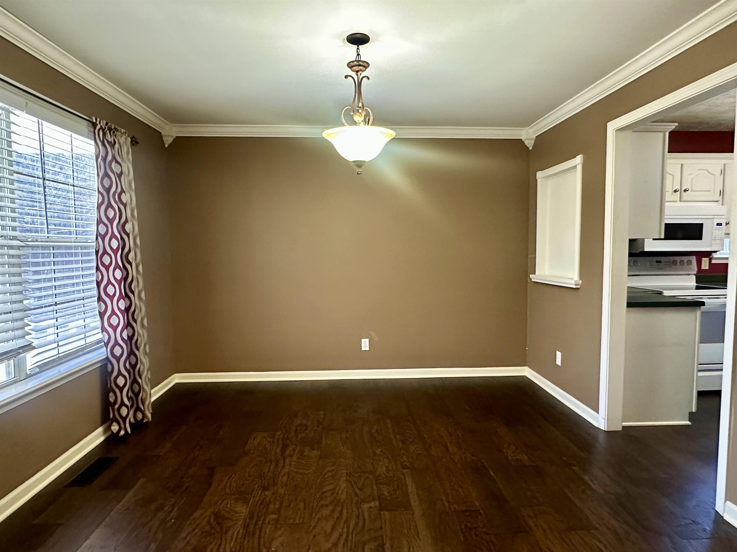 3566 Highway 142 Selmer, TN 38375 - Photo 18 of 20 Unfurnished dining area featuring dark wood finished floors and ornamental molding