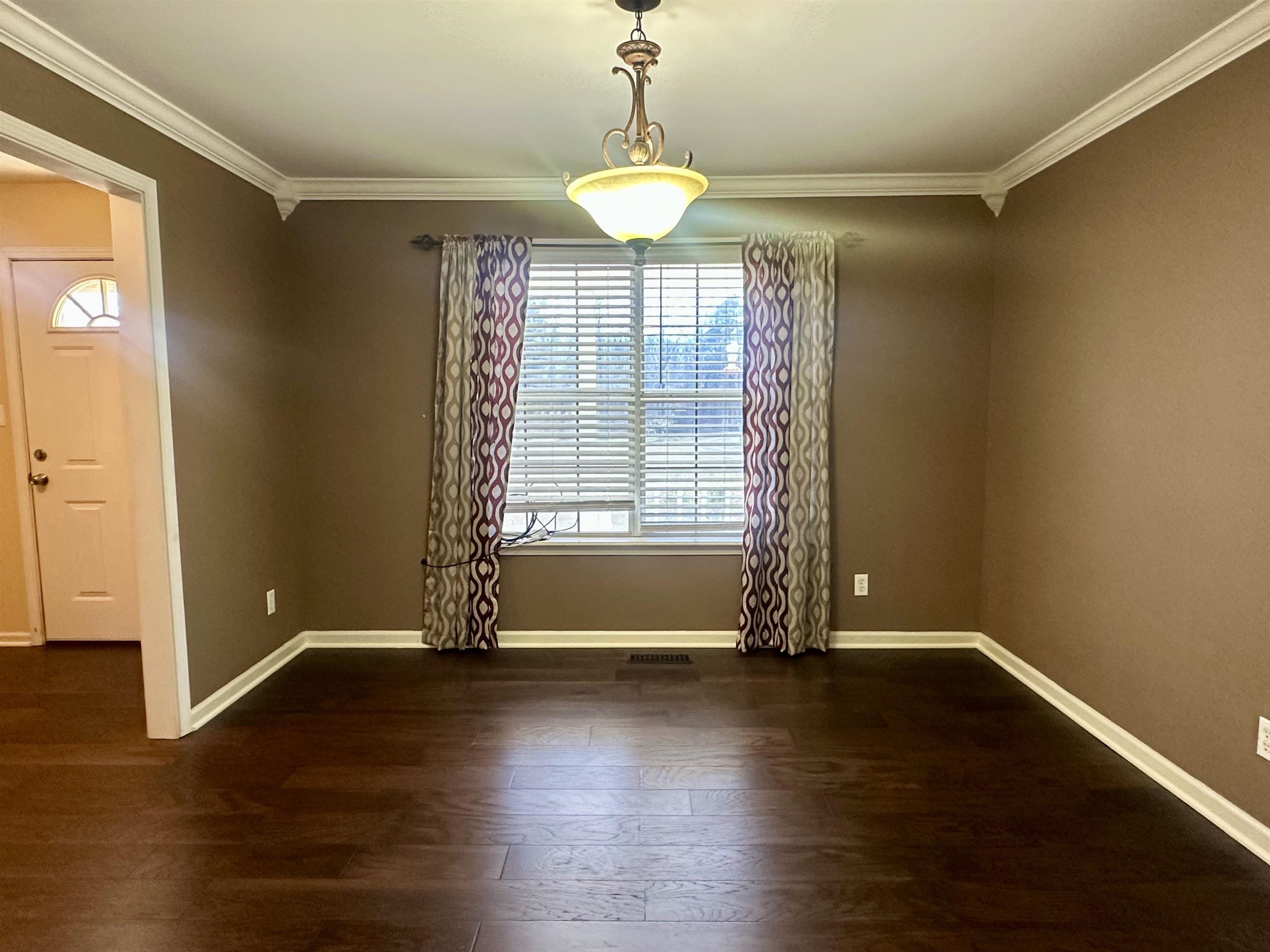 3566 Highway 142 Selmer, TN 38375 - Photo 19 of 20 Unfurnished dining area with crown molding and dark wood-type flooring
