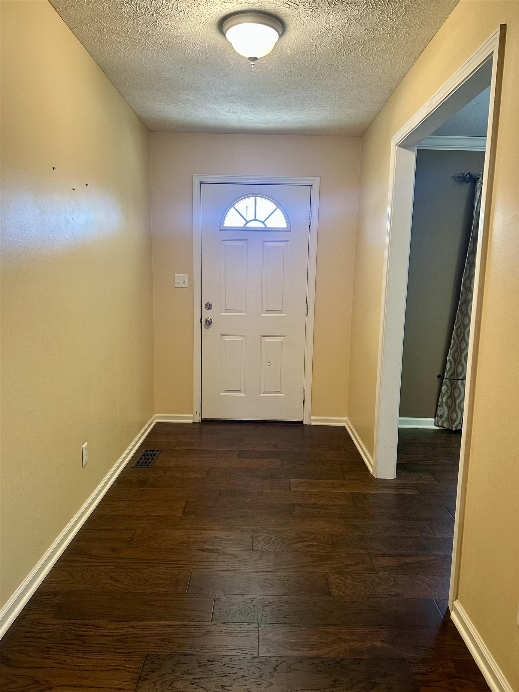 3566 Highway 142 Selmer, TN 38375 - Photo 2 of 20 Entryway featuring wood-type flooring and a textured ceiling
