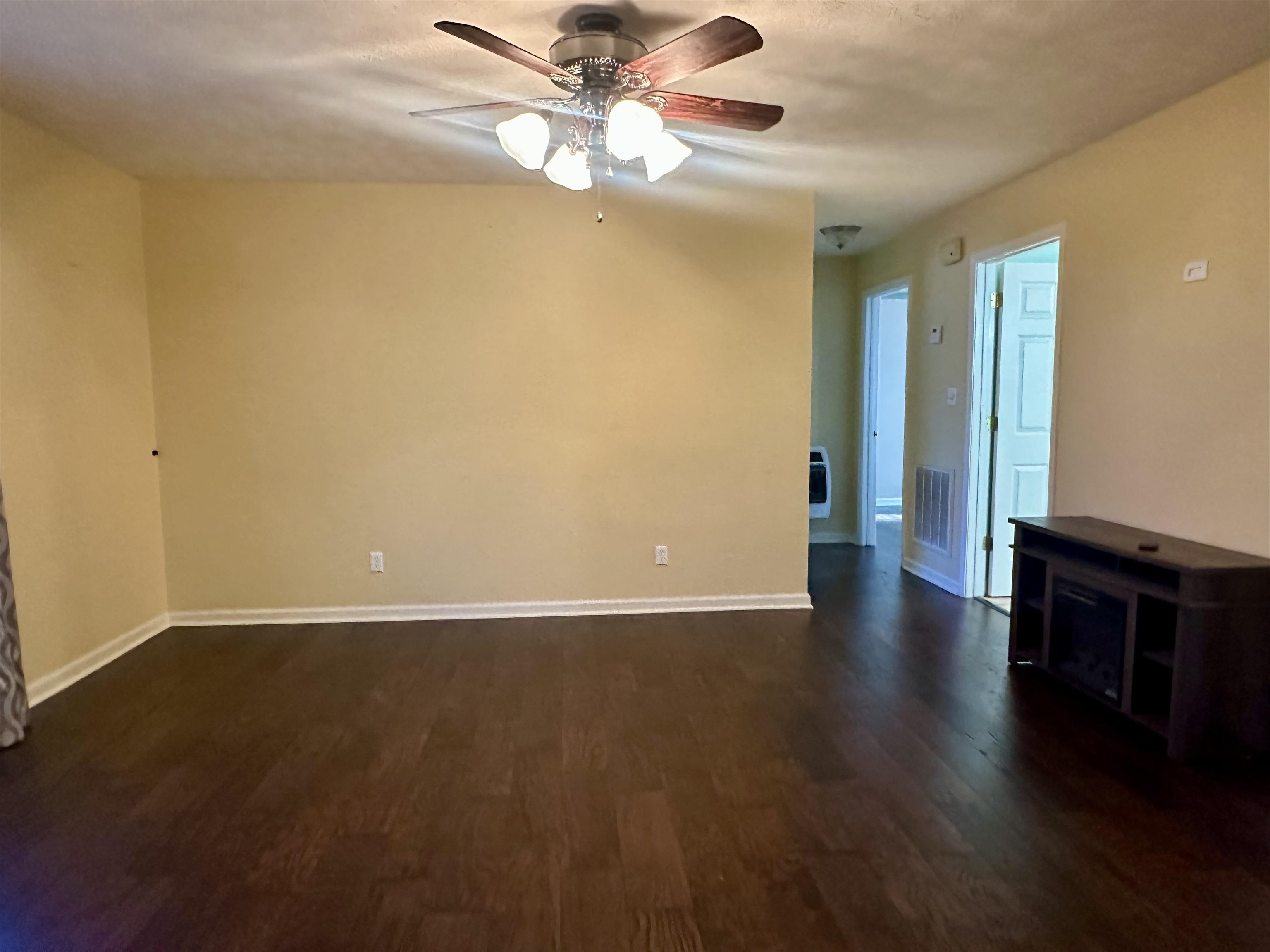 3566 Highway 142 Selmer, TN 38375 - Photo 4 of 20 Spare room with ceiling fan, dark wood-type flooring, and heating unit