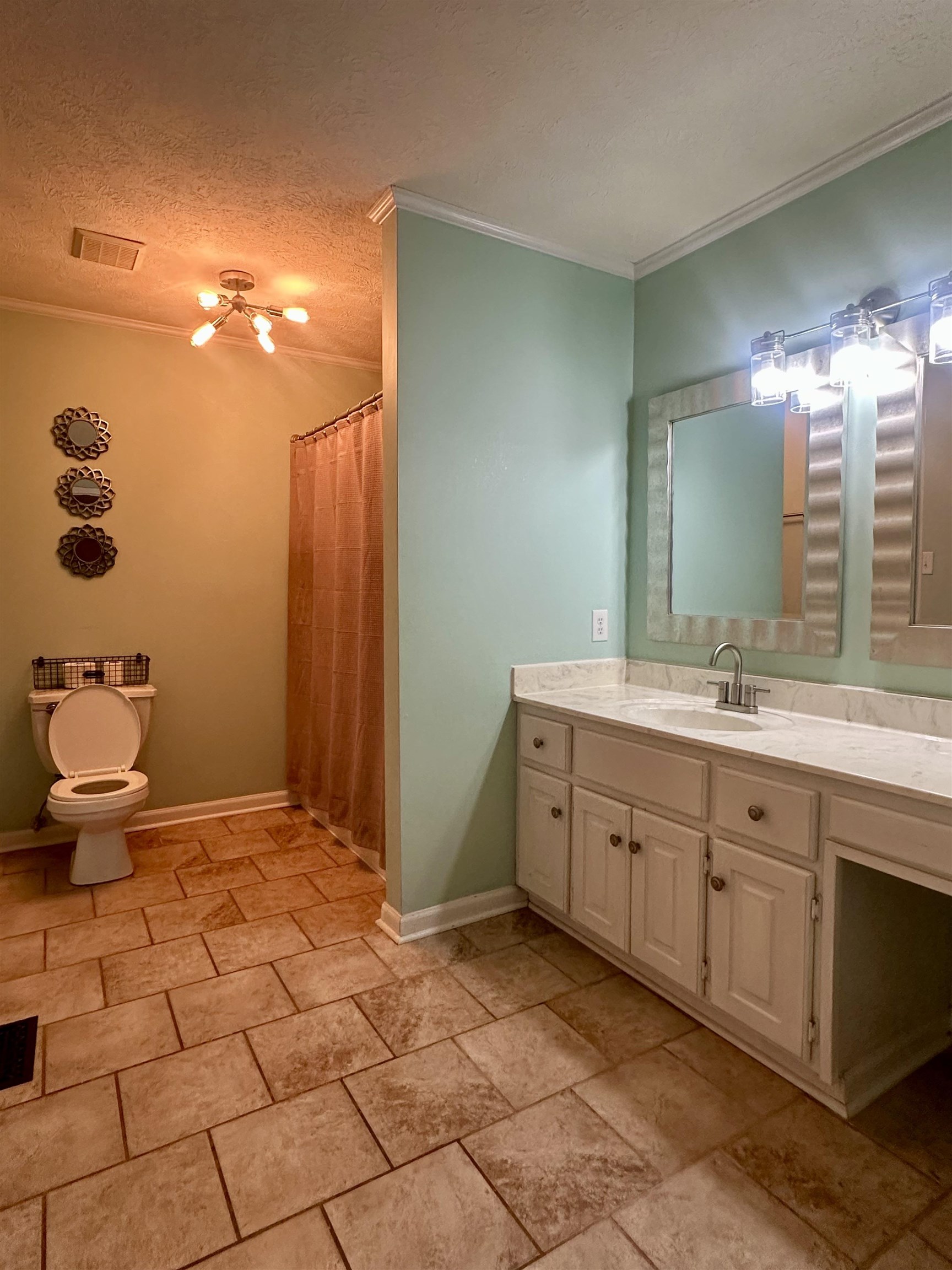 3566 Highway 142 Selmer, TN 38375 - Photo 8 of 20 Full bathroom with a shower with shower curtain, a textured ceiling, vanity, crown molding, and stone tile floors