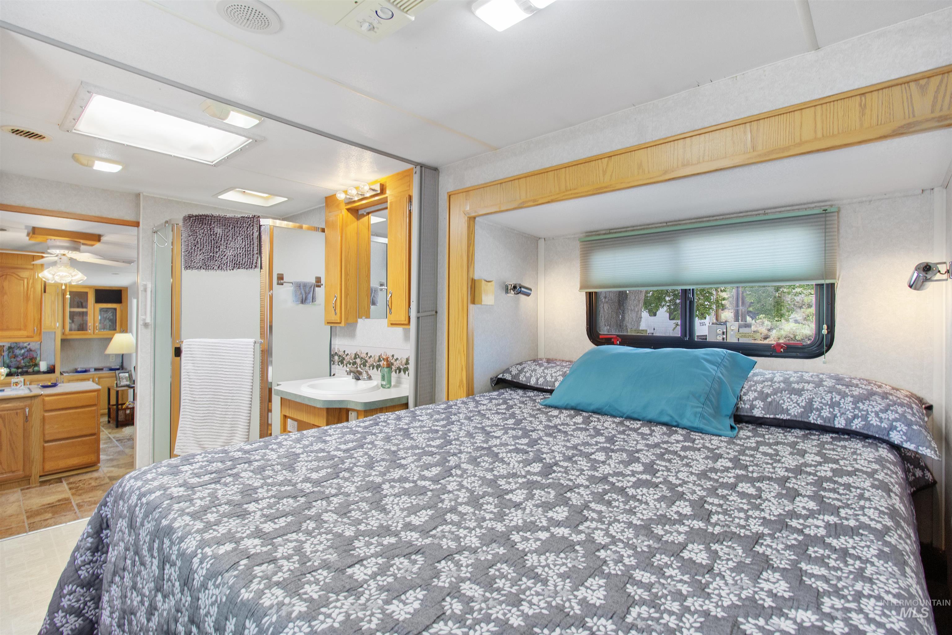 106 West Magic Road Shoshone, ID 83352 - Photo 23 of 45 Interior sleeping area featuring a built-in bed platform, recessed lighting, and a window with a roller blind