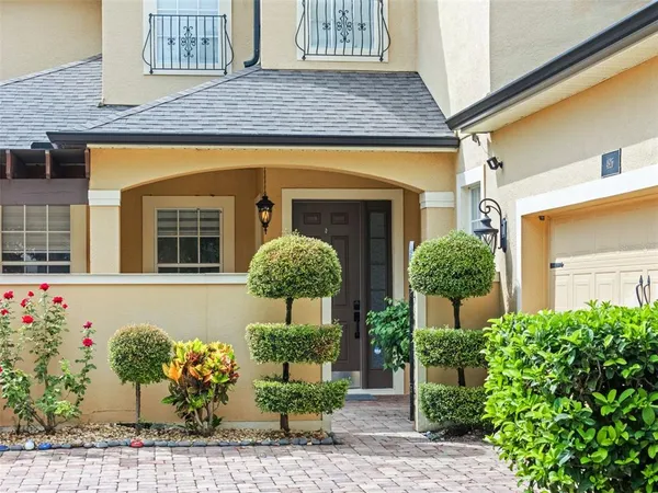 a front view of house with flowers