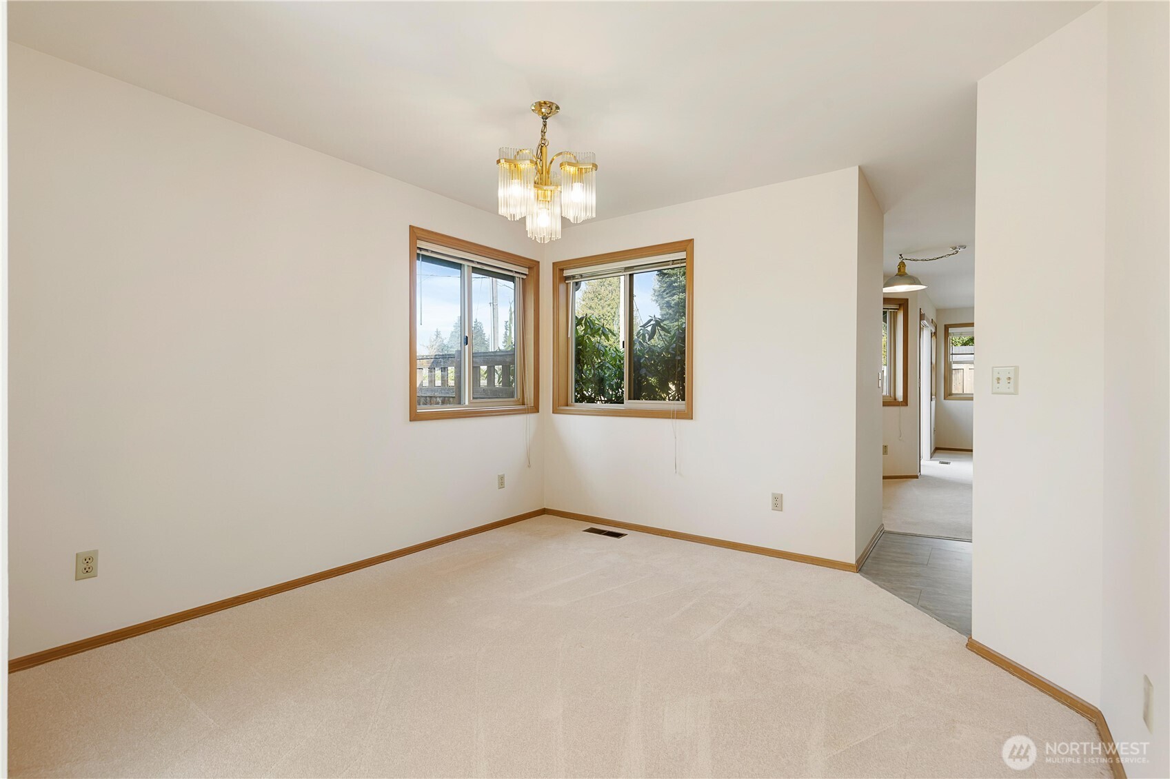 8523 199th Place Southwest Edmonds, WA 98026 - Photo 12 of 40 an empty room with windows and chandelier