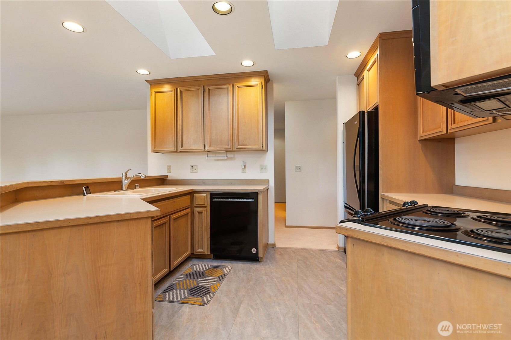 8523 199th Place Southwest Edmonds, WA 98026 - Photo 13 of 40 a kitchen with a sink stove and refrigerator