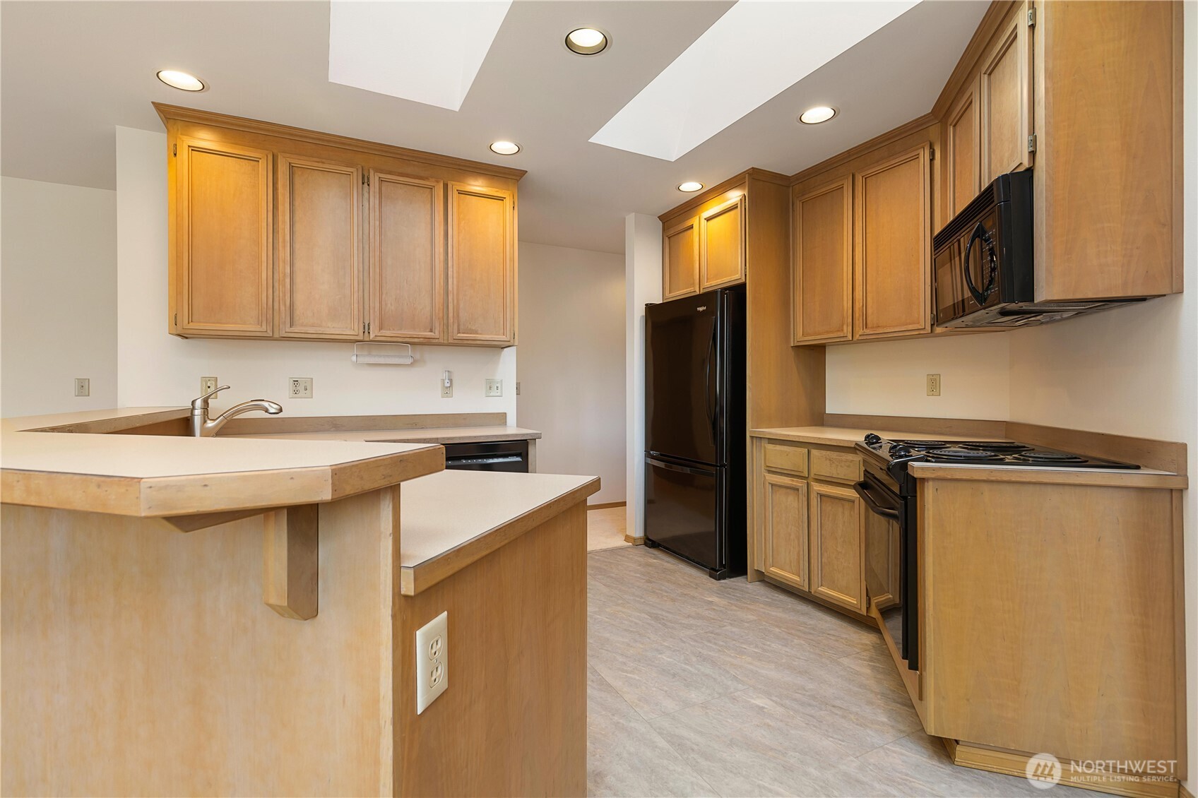 8523 199th Place Southwest Edmonds, WA 98026 - Photo 14 of 40 a kitchen with stainless steel appliances a sink cabinets and a refrigerator