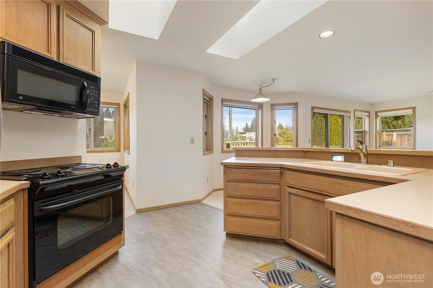 8523 199th Place Southwest Edmonds, WA 98026 - Photo 16 of 40 a kitchen with a sink stove and microwave