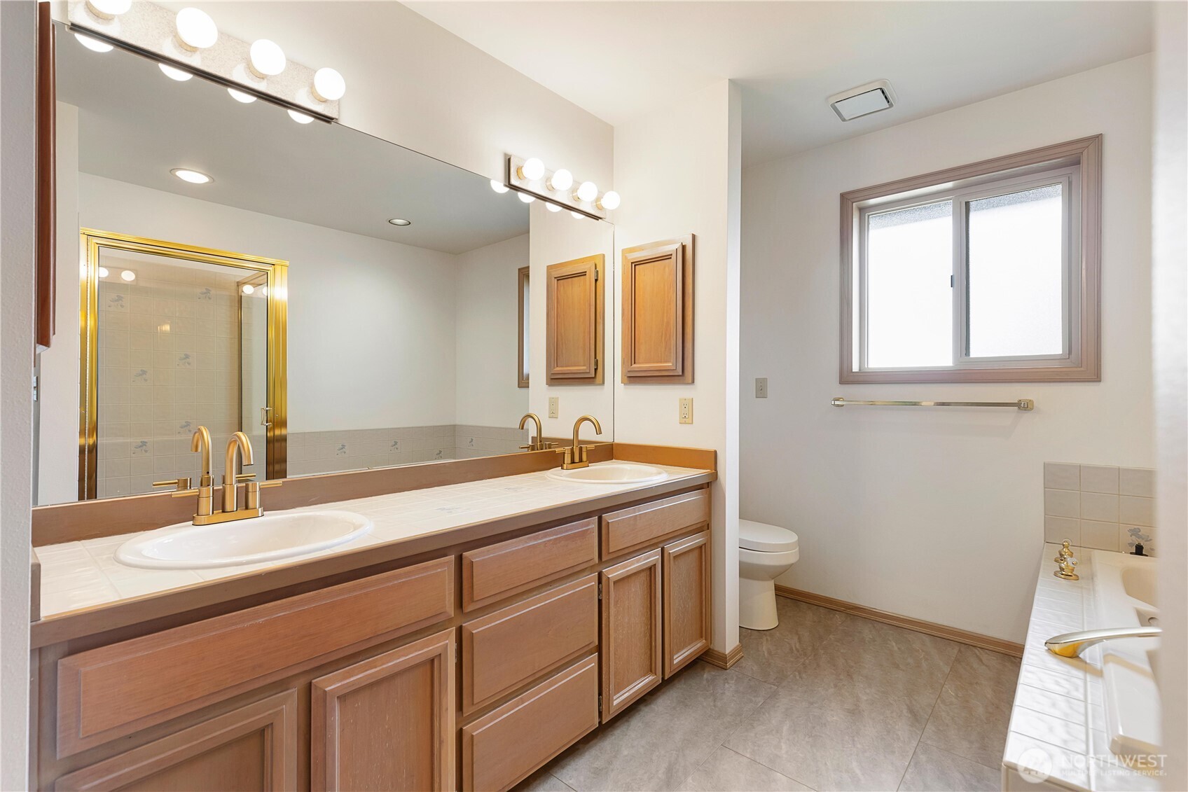 8523 199th Place Southwest Edmonds, WA 98026 - Photo 25 of 40 a bathroom with a double vanity sink and a mirror