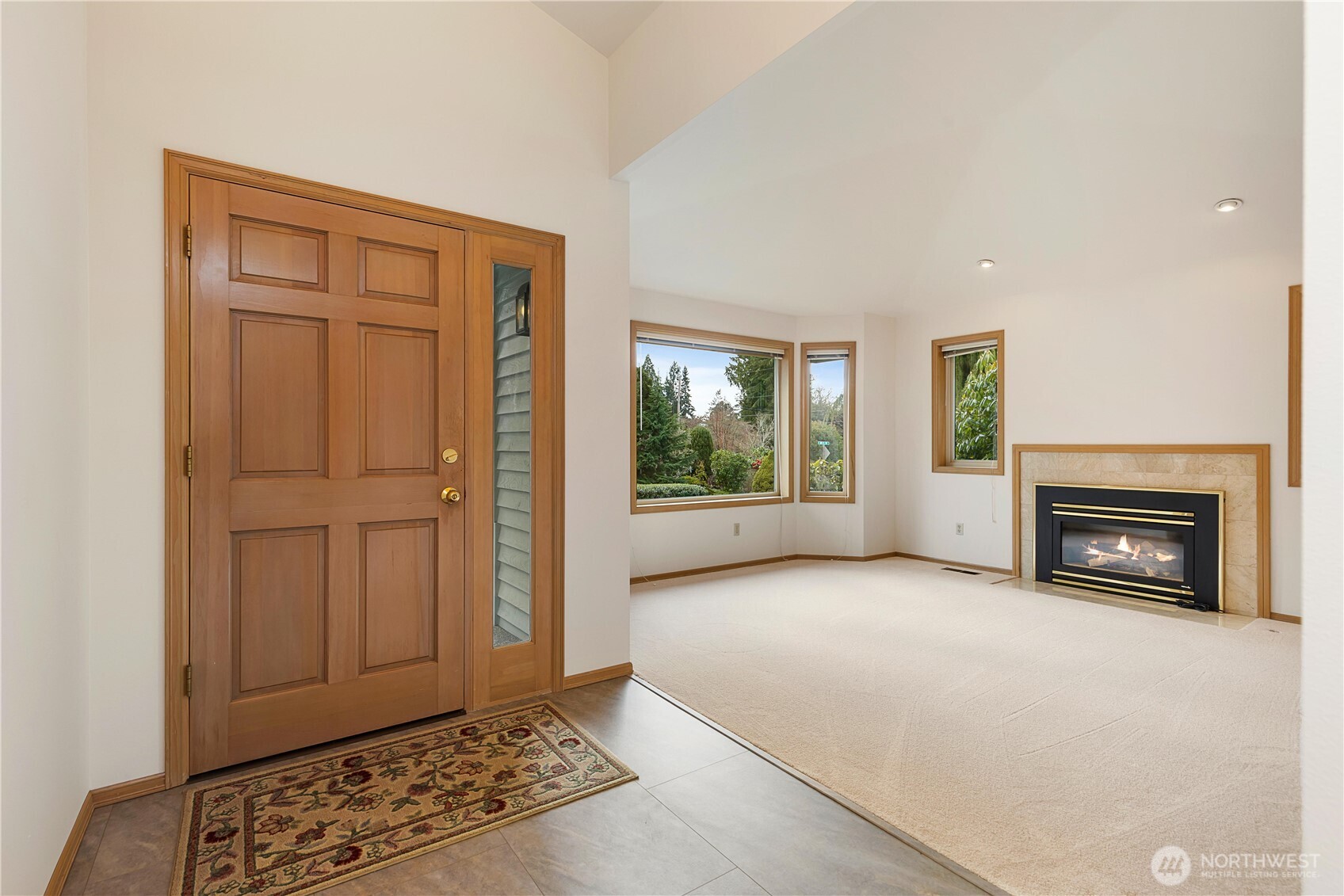 8523 199th Place Southwest Edmonds, WA 98026 - Photo 5 of 40 a view of an empty room with a fireplace and a window