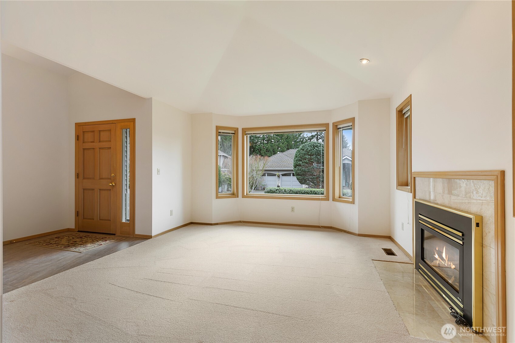 8523 199th Place Southwest Edmonds, WA 98026 - Photo 8 of 40 an empty room with windows and fireplace