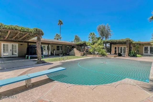 a view of house with outdoor space and swimming pool