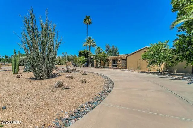 a view of a dry yard with a house