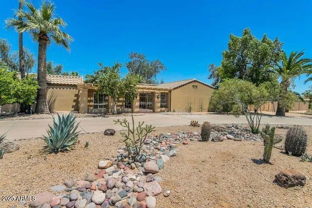 a front view of a house with a yard covered with snow
