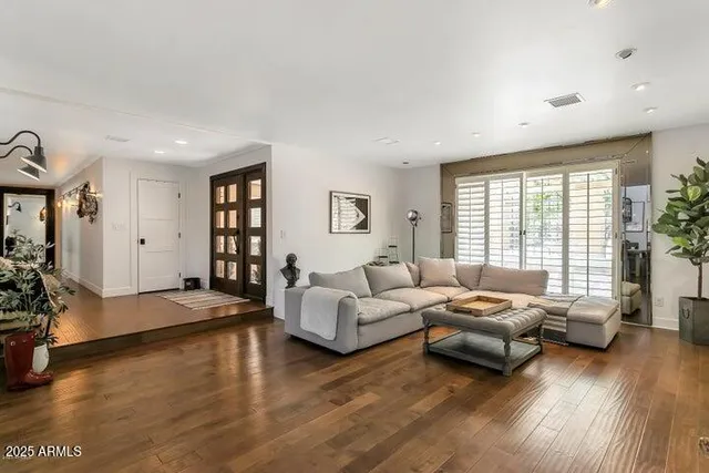 a living room with furniture window and wooden floor