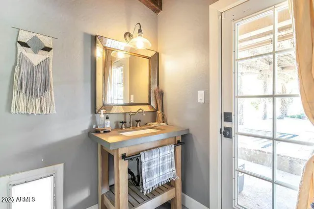 a bathroom with a sink a mirror and a window