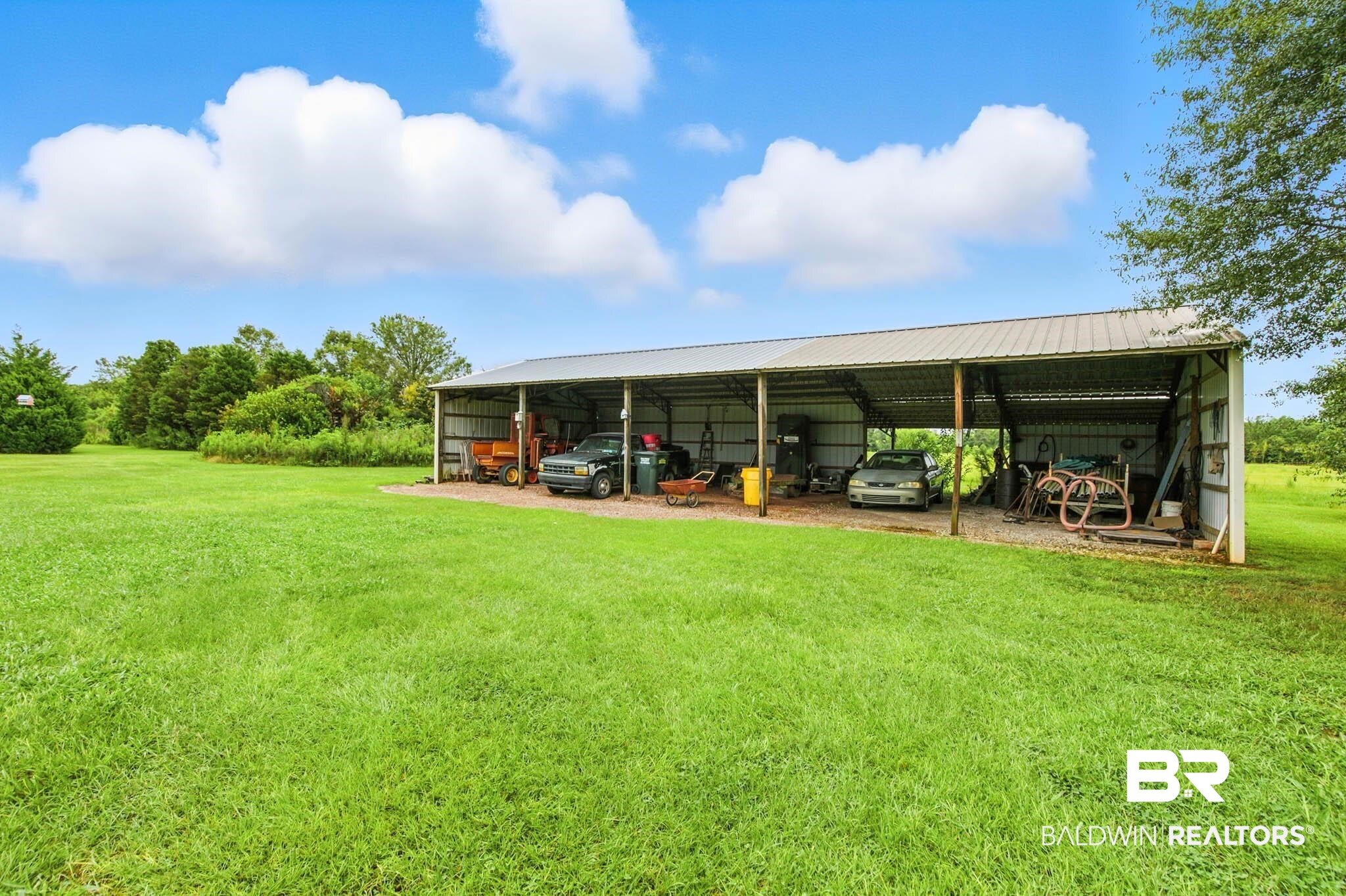 17270 Davis Road Summerdale, AL 36580 - Photo 83 of 97 View of pole building featuring a yard and a detached carport
