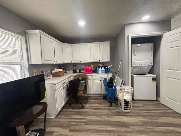 a kitchen with a refrigerator and a stove top oven