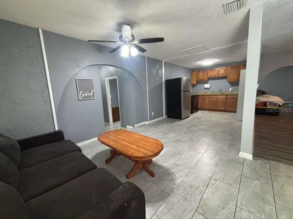 a living room with furniture and a chandelier