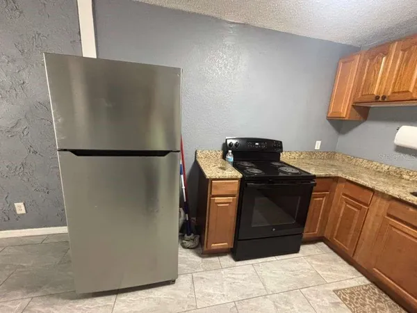 a kitchen with a refrigerator and a stove