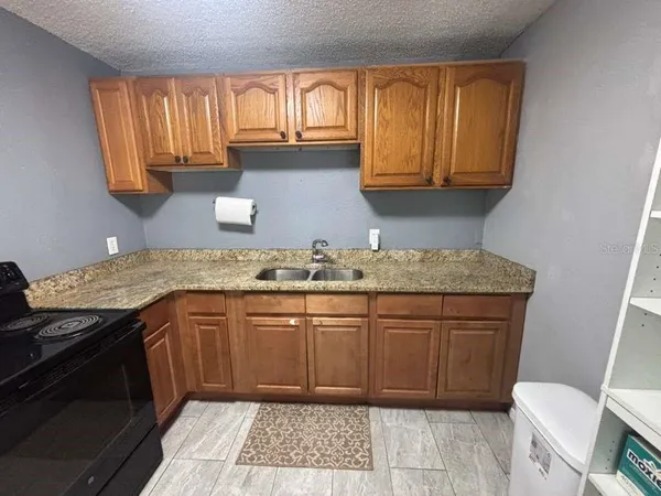 a kitchen with a sink stove and cabinets