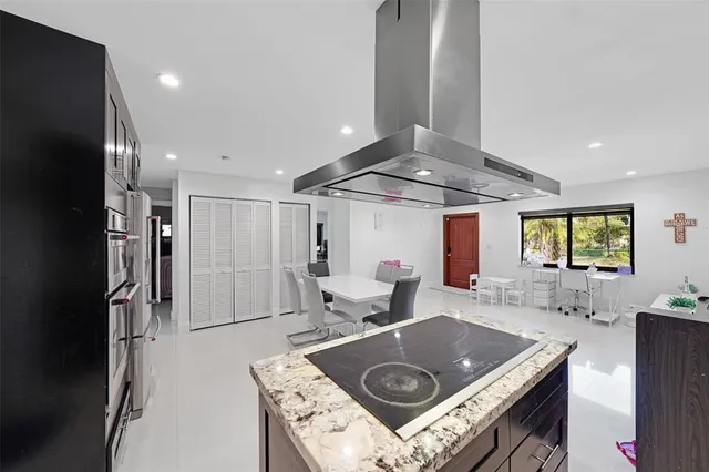 a kitchen with a stove a refrigerator and a sink