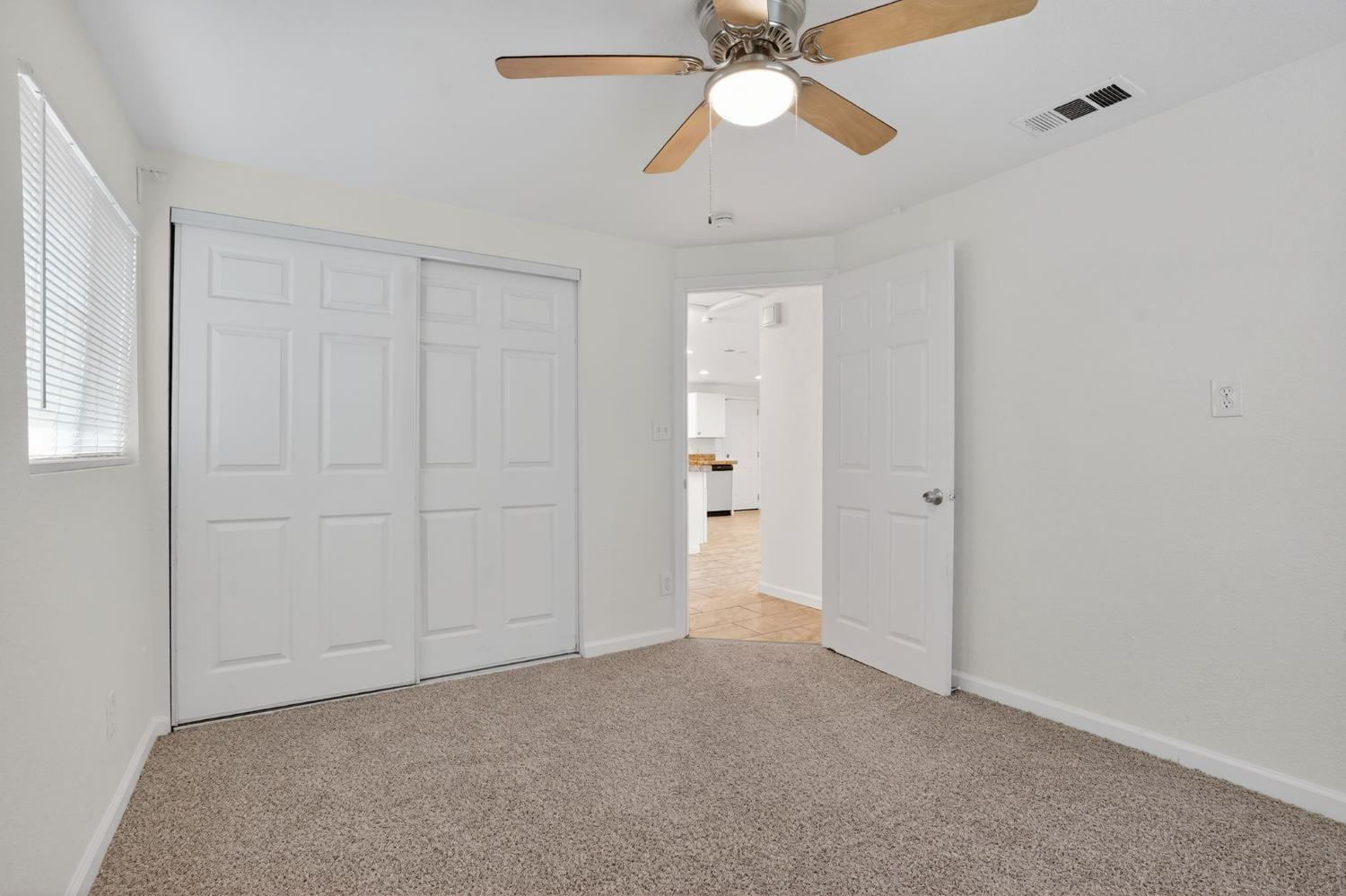 418 East Granger Avenue Modesto, CA 95350 - Photo 11 of 23 an empty room with closet and a chandelier fan