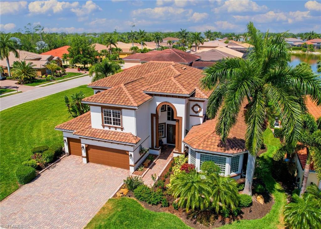 an aerial view of a house with a garden and lake view