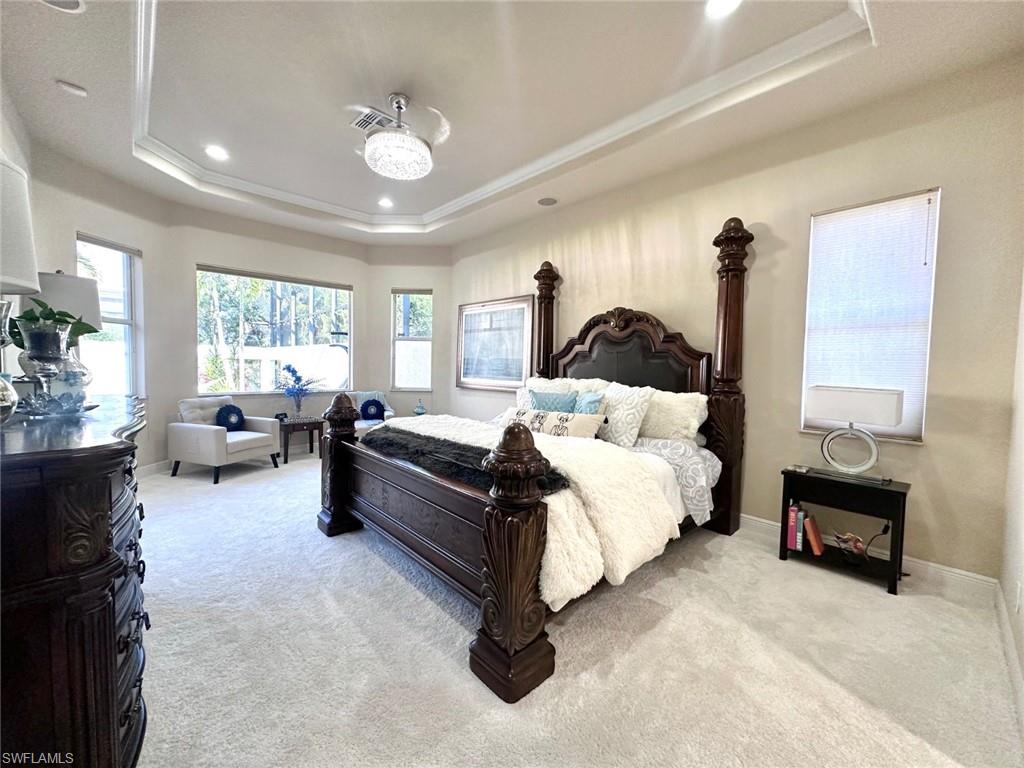 19261 La Serena Drive Estero, FL 33967 - Photo 11 of 48 a spacious bedroom with a bed couch and windows