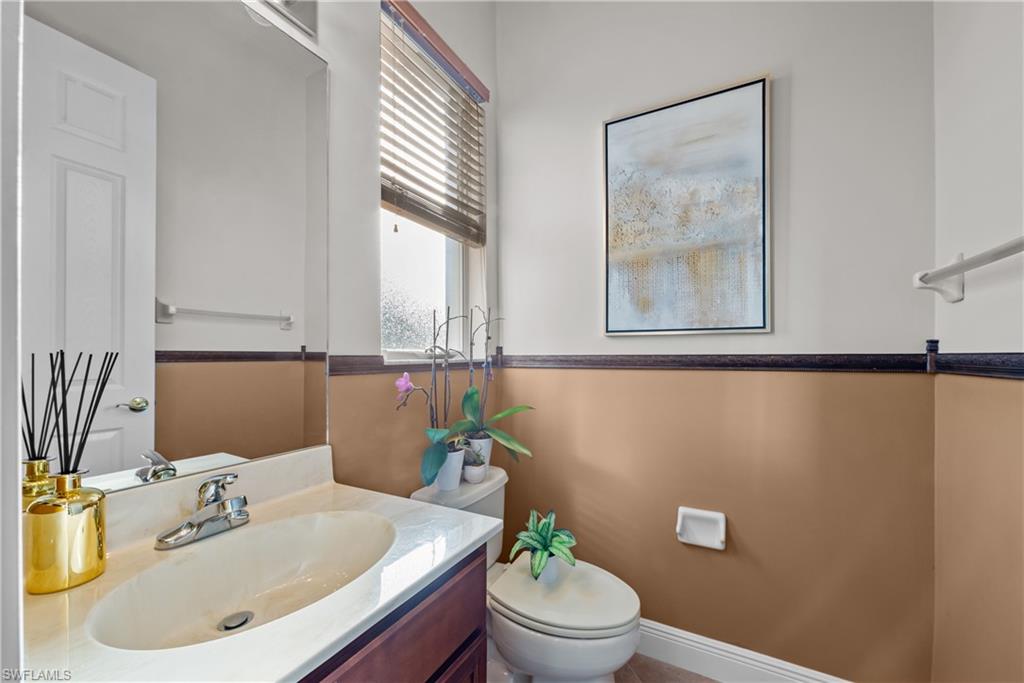 19261 La Serena Drive Estero, FL 33967 - Photo 29 of 48 a bathroom with a sink mirror and toilet