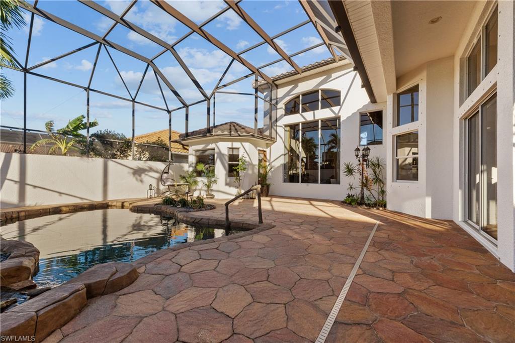 19261 La Serena Drive Estero, FL 33967 - Photo 34 of 48 a view of a patio with table and chairs