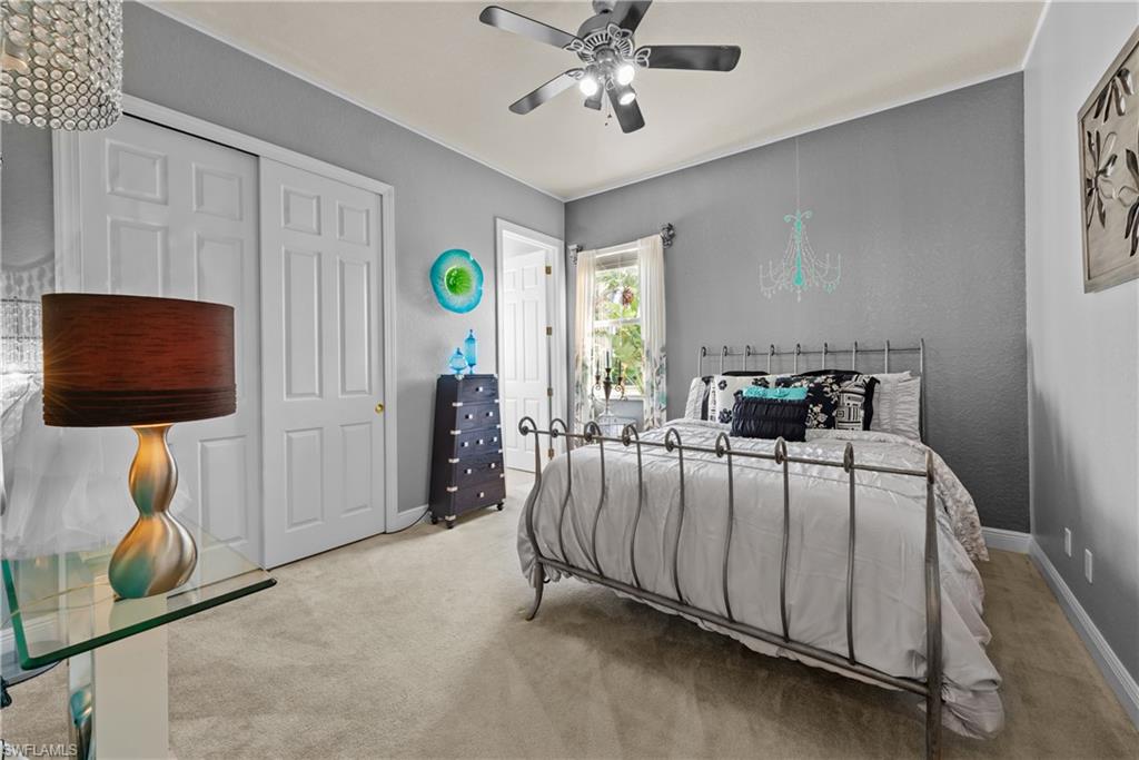 19261 La Serena Drive Estero, FL 33967 - Photo 37 of 48 a bedroom with a bed and a chandelier