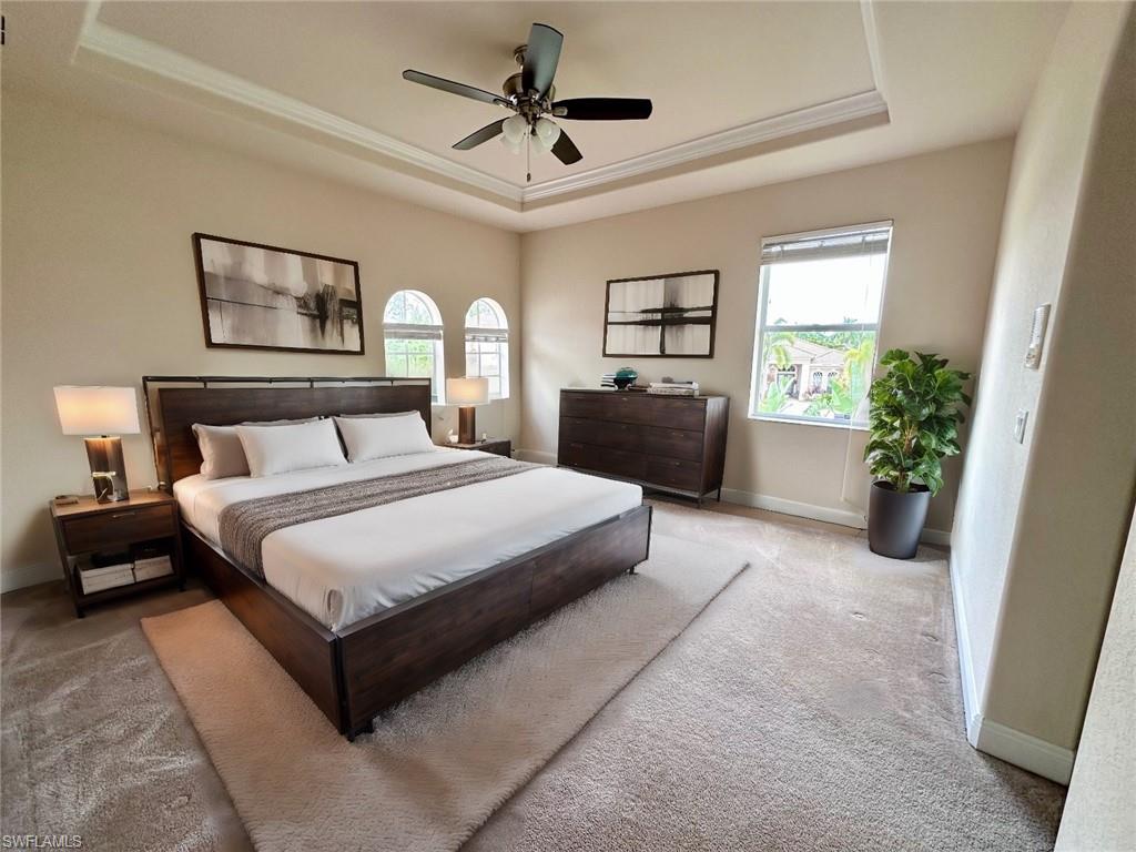 19261 La Serena Drive Estero, FL 33967 - Photo 47 of 48 a bedroom with a large bed and a chandelier