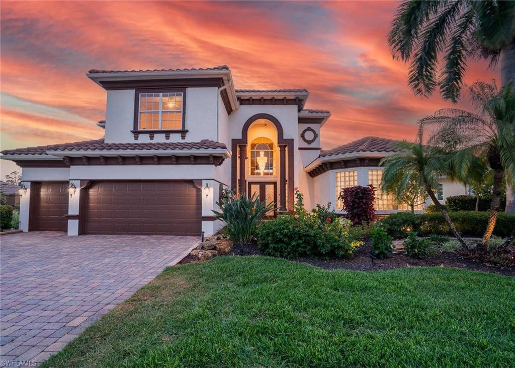 19261 La Serena Drive Estero, FL 33967 - Photo 48 of 48 a front view of a house with yellow lighting on it
