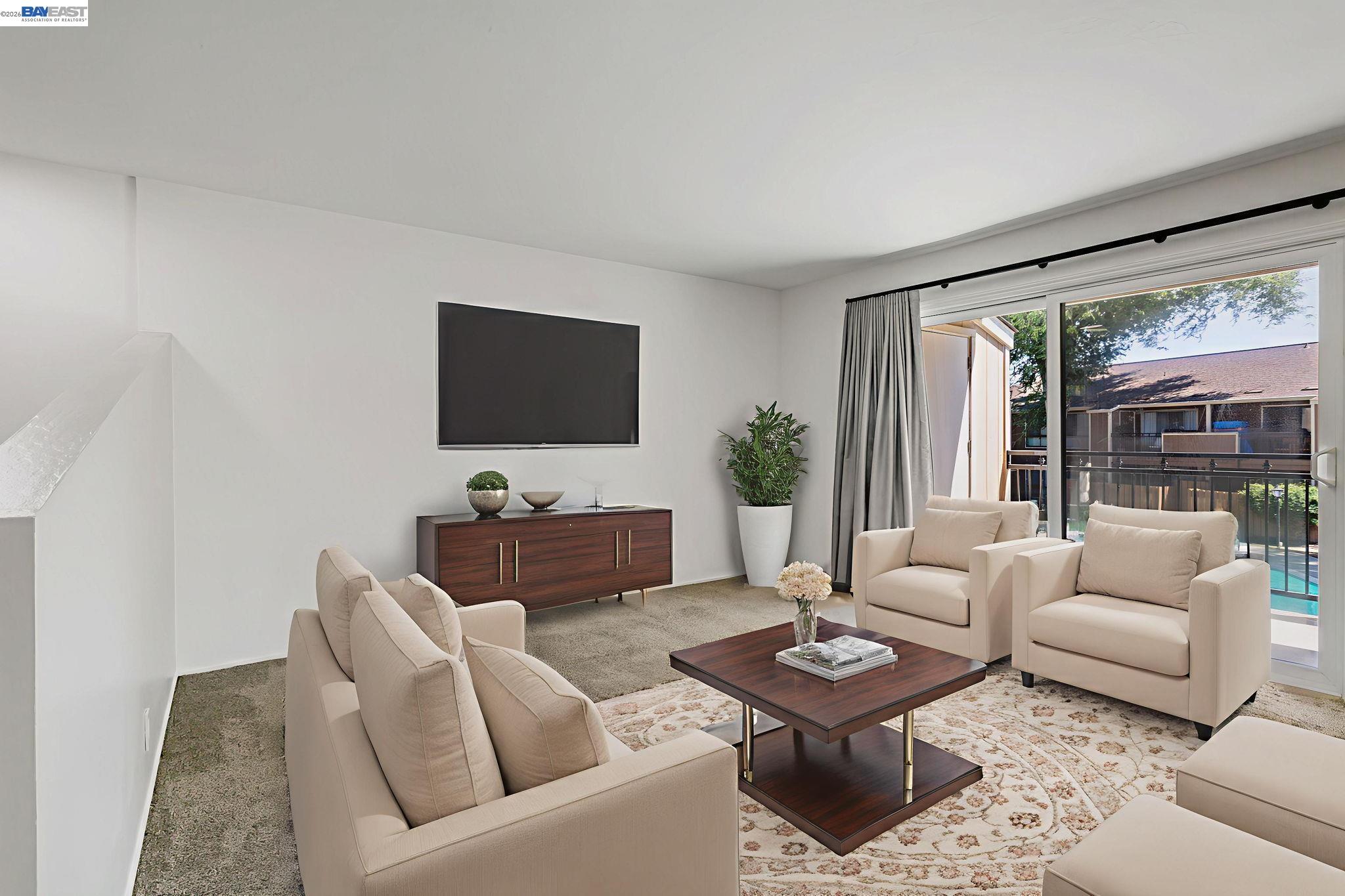 Large bright open living room with lots of wall space  for easy decorating.  This room is virtually staged.