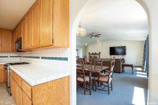 a view of a dining room with furniture and a window