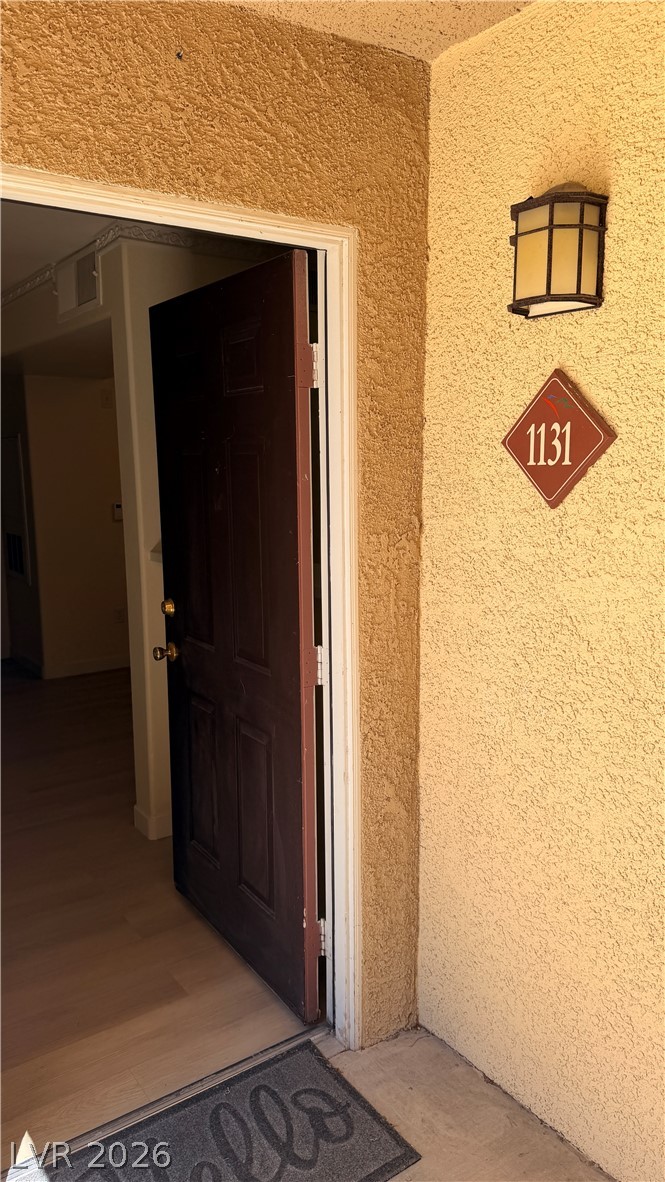 7885 West Flamingo Road, Unit 1131 Las Vegas, NV 89147 - Photo 11 of 36 A welcoming entry point with a stylish outdoor sconce and clearly marked house numbers.