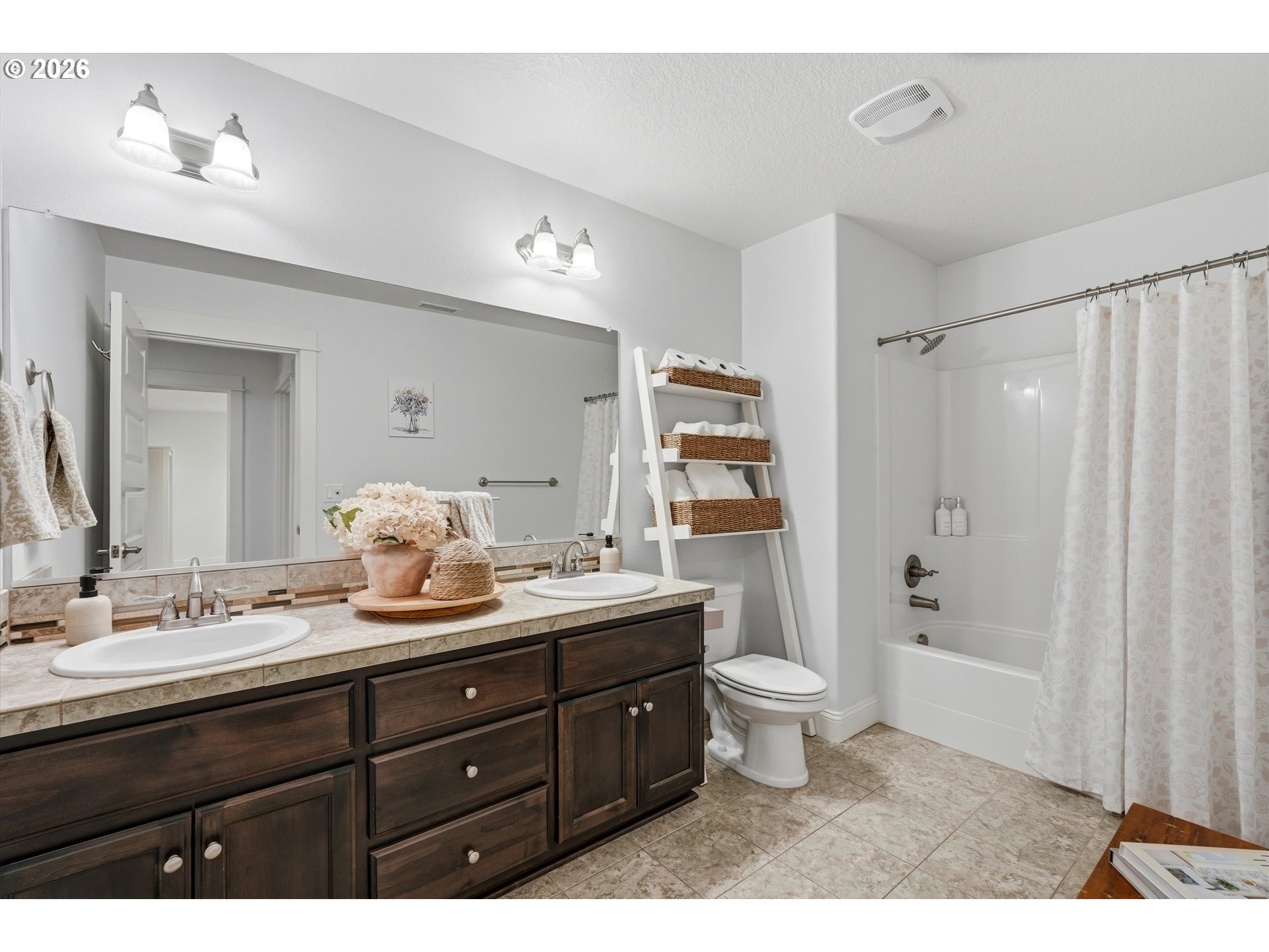 2923 Southwest 40th Street Gresham, OR 97080 - Photo 17 of 37 a bathroom with a granite countertop sink toilet a large mirror a bathtub and shower