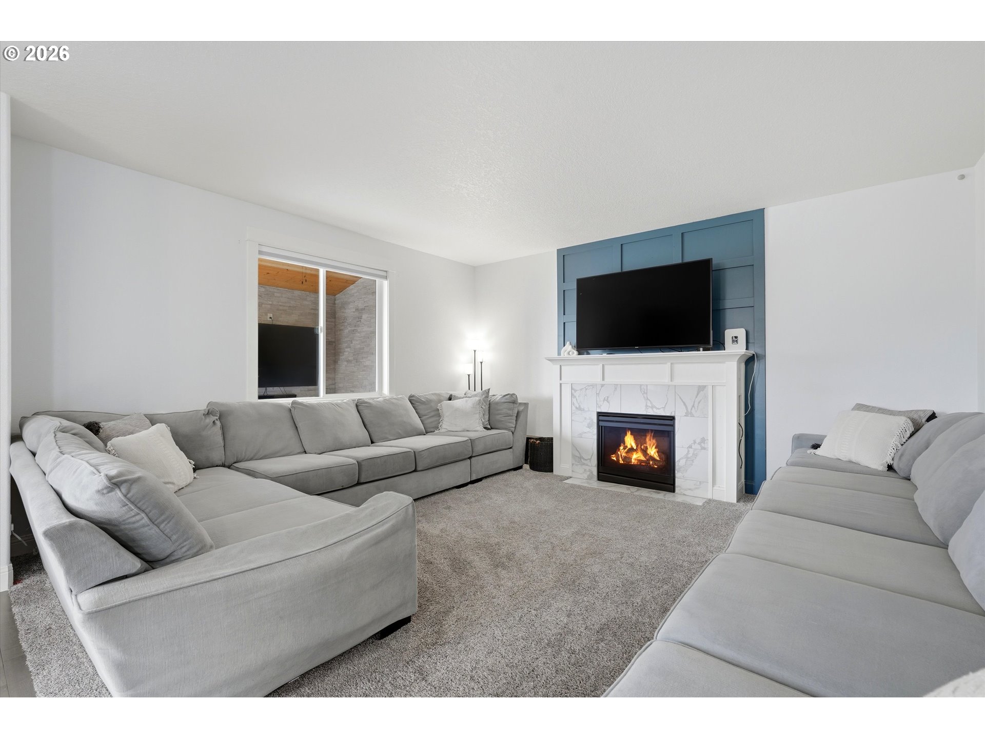 2923 Southwest 40th Street Gresham, OR 97080 - Photo 27 of 37 a living room with furniture a fireplace and a flat screen tv