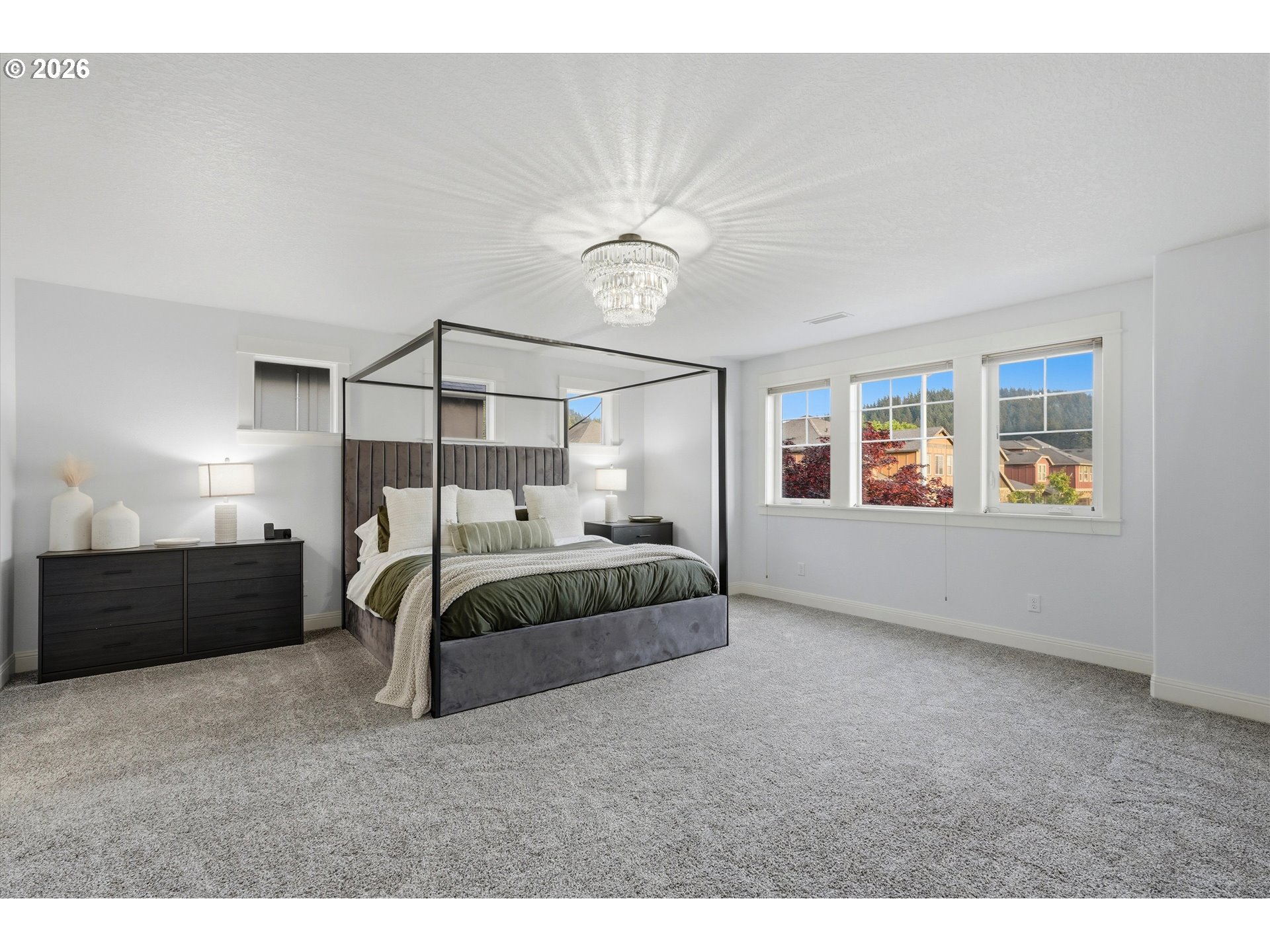 2923 Southwest 40th Street Gresham, OR 97080 - Photo 10 of 37 a bedroom with a bed and a chandelier