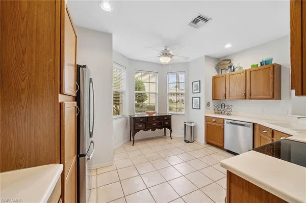 a kitchen with a sink and chairs