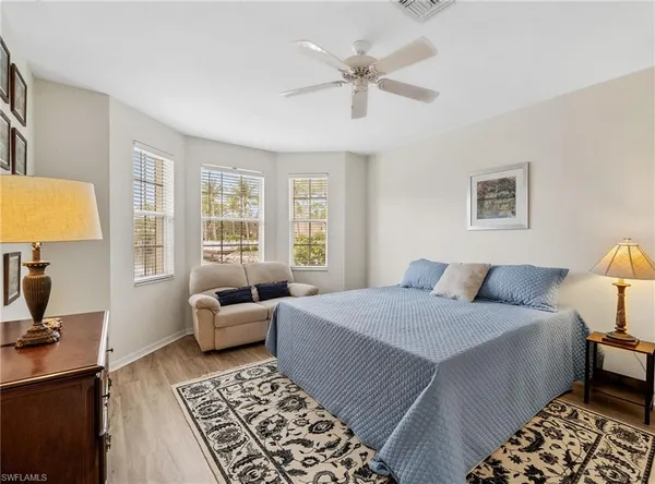 a bedroom with a large bed and a window