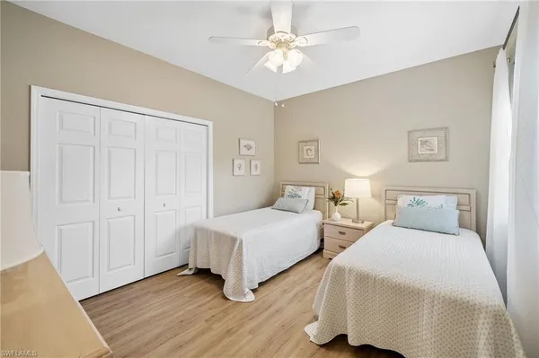 a bedroom with two beds and a chandelier