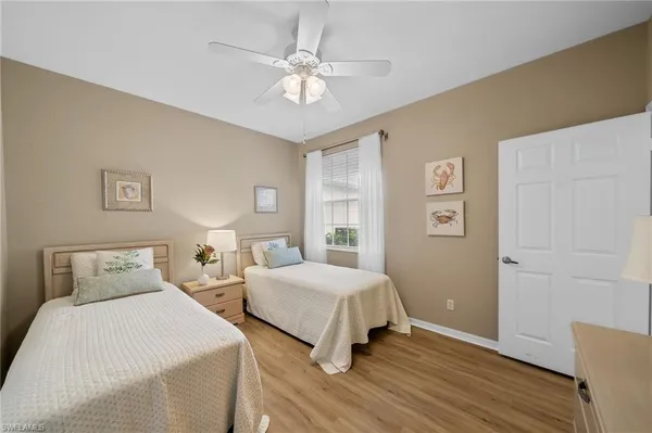 a bedroom with two beds and a chandelier