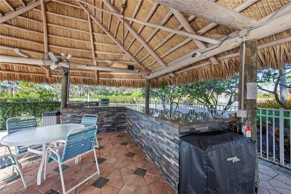 a view of a patio with table and chairs with wooden floor and plants