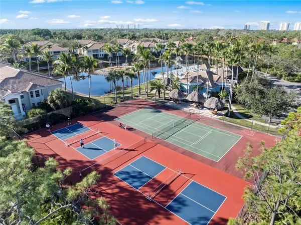 an aerial view of a tennis ground and a houses
