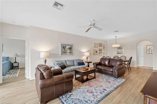 a living room with furniture and wooden floor