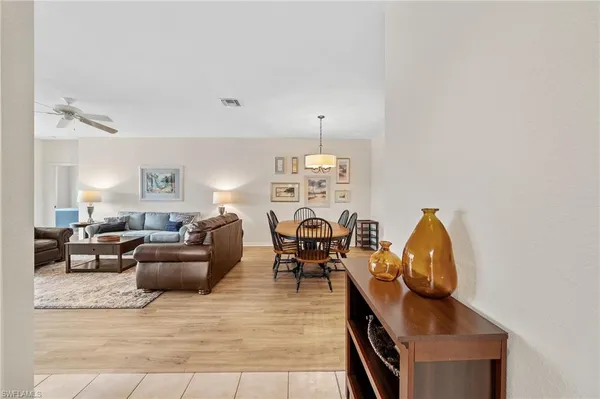 a living room with furniture a chandelier and a fireplace