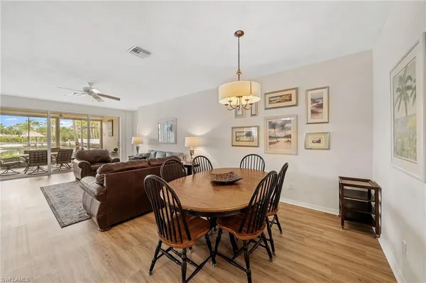 a view of a dining room with furniture wooden floor and chandelier