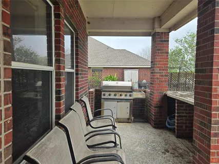 a balcony with furniture and a floor to ceiling window