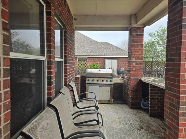 a balcony with furniture and a floor to ceiling window